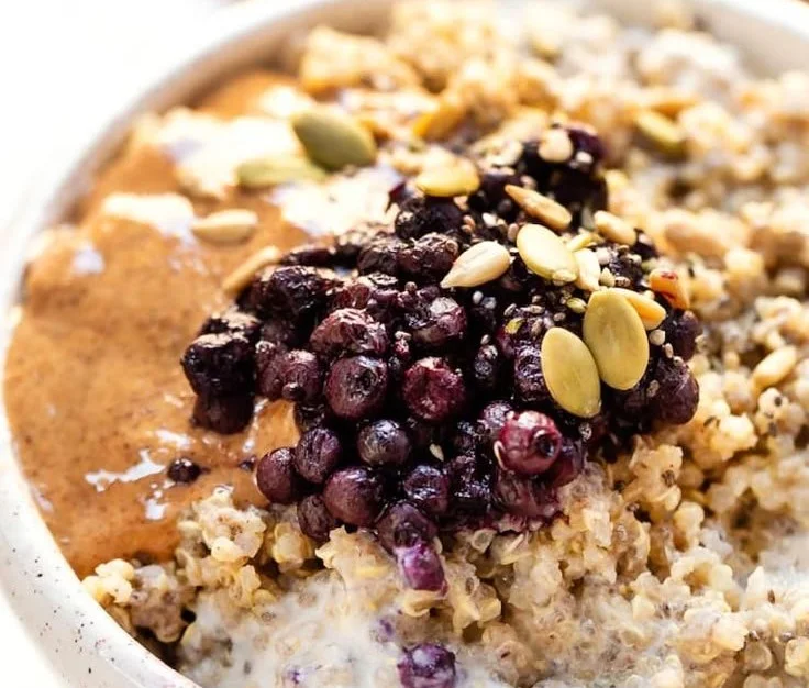 Bowl of chai spiced quinoa topped with fruits and nuts for a healthy breakfast.