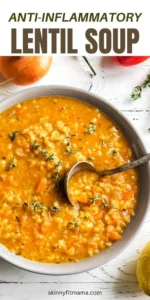 Bowl of anti-inflammatory red lentil soup topped with herbs and spices