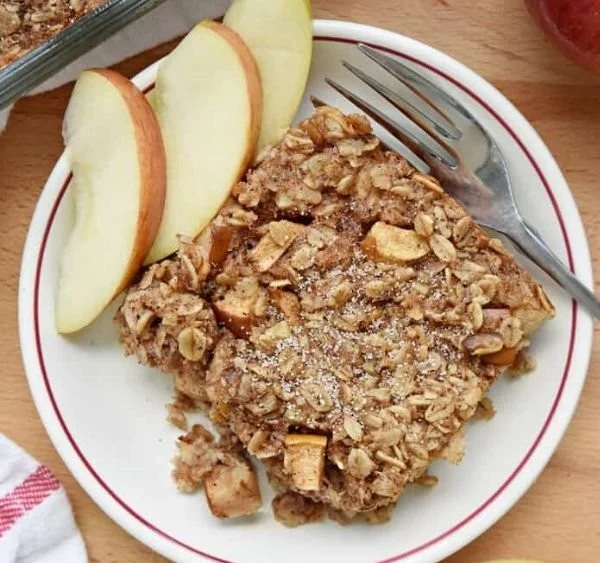 Delicious apple cinnamon baked oatmeal served in a bowl with fresh apples
