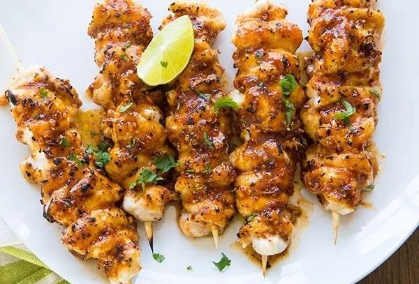 Grilled chicken skewers with vegetables served on a plate