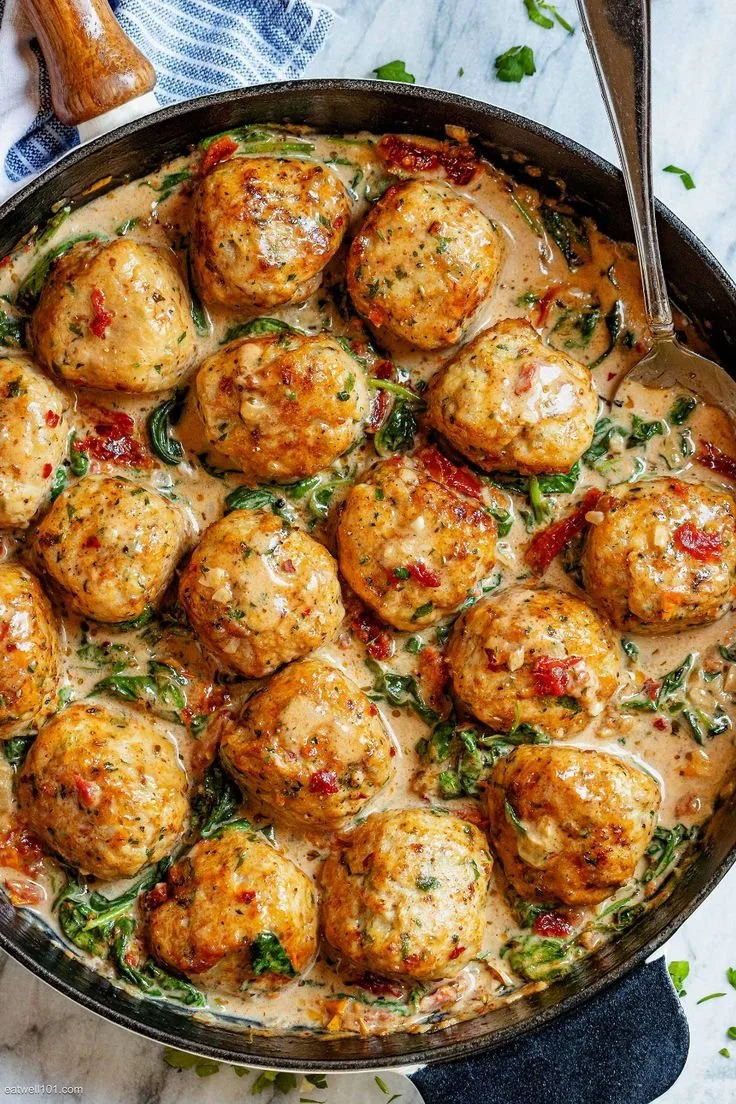 Creamy spinach turkey meatballs served on a plate with sauce