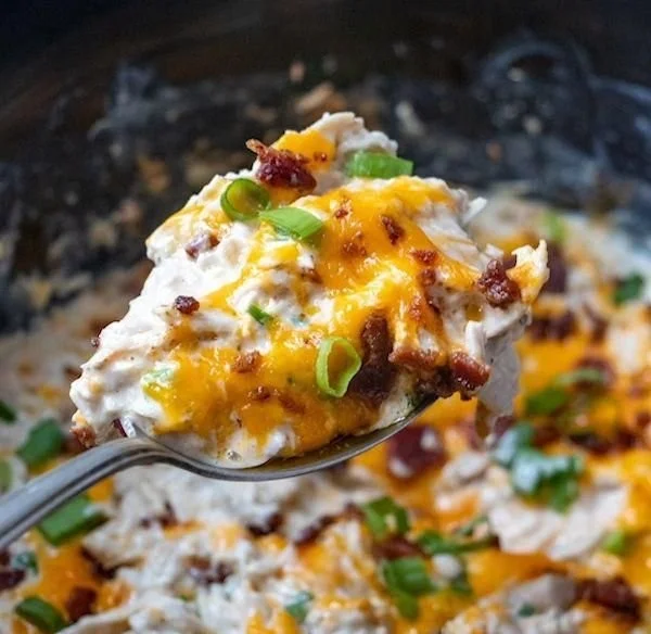 Delicious Crock Pot Crack Chicken served in a bowl with herbs and toppings