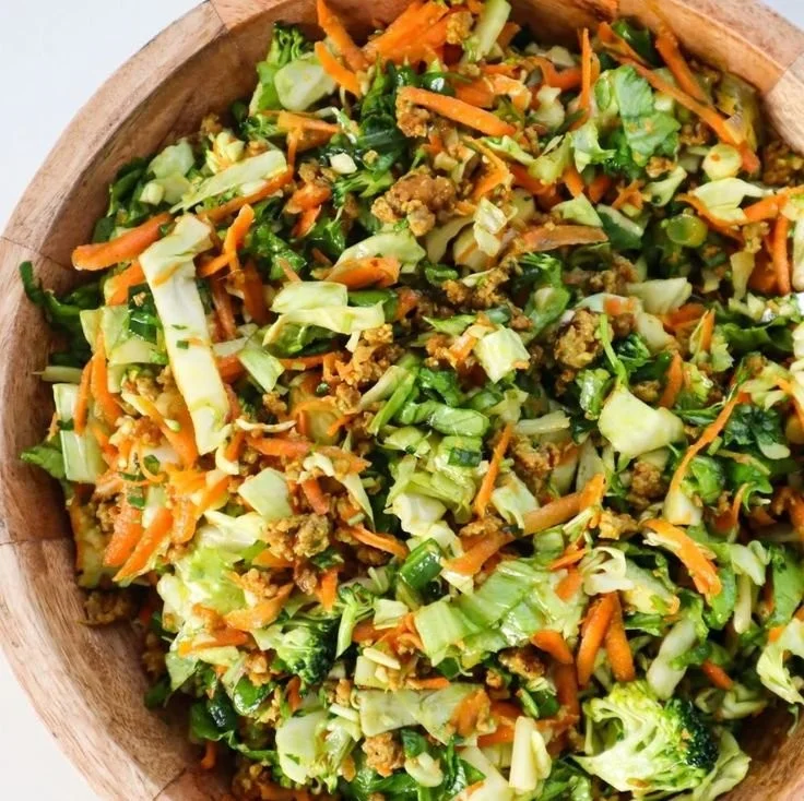 Bowl of Egg Roll Salad with colorful vegetables and dressing