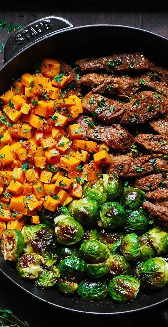 Plate of Garlic Butter Steak served with Brussels Sprouts and Sweet Potatoes