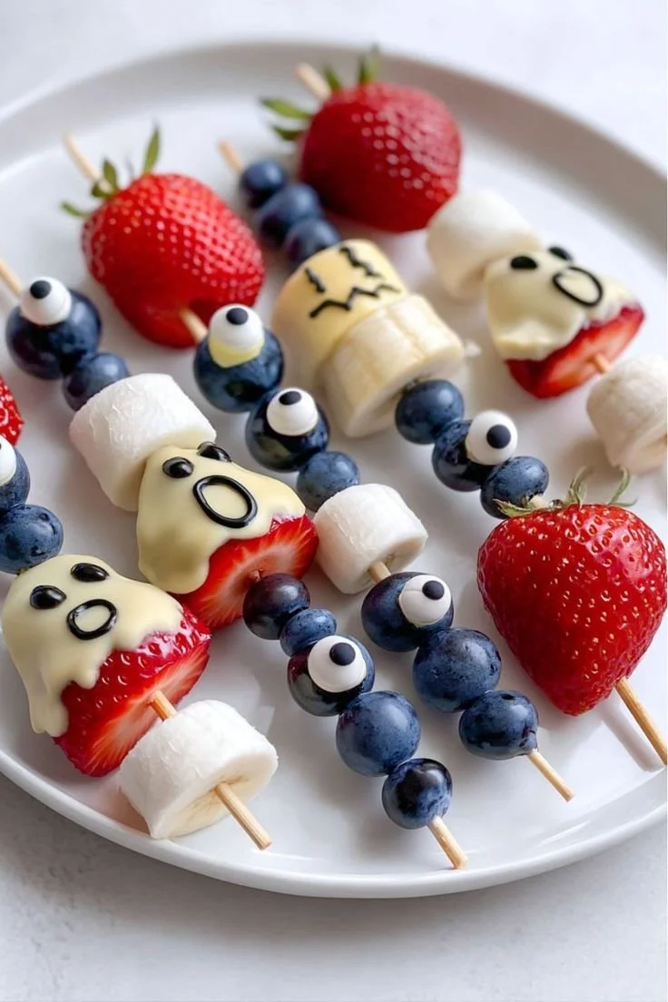 Spooky Halloween skewers made with ghost-shaped fruit for a festive celebration.