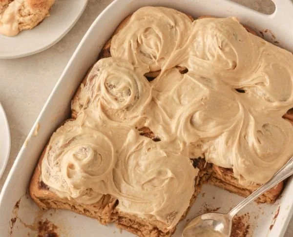 Freshly baked gingerbread cinnamon rolls drizzled with icing
