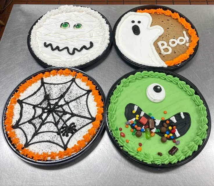 Delicious Halloween cookie cakes decorated with spooky designs.