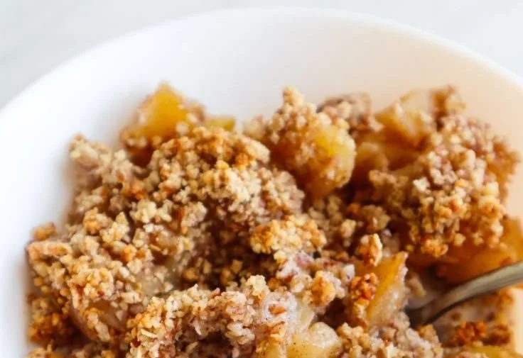 Healthy breakfast apple crumble topped with nuts and fruits
