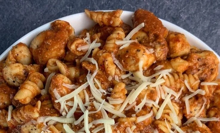 Healthy Garlic Parmesan Chicken Pasta garnished with parsley and parmesan cheese