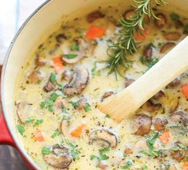 Bowl of Mushroom Chicken Soup with fresh herbs and vegetables