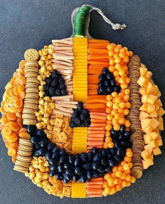Colorful pumpkin snack boards filled with seasonal treats for fall entertaining.