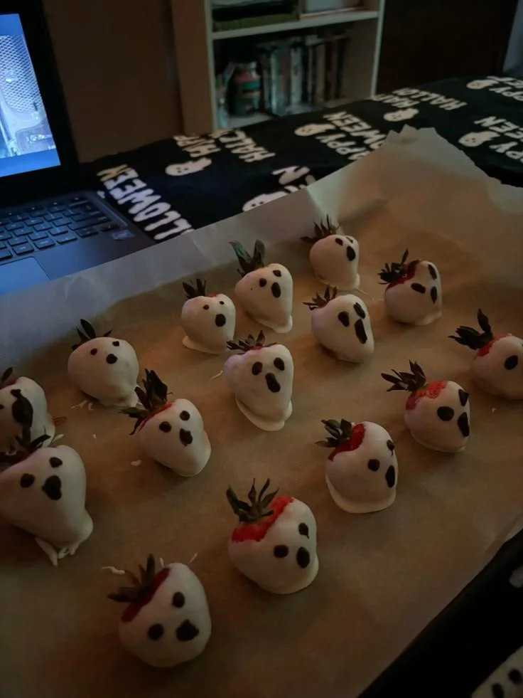 Scream-inspired chocolate covered strawberries with spooky decorations