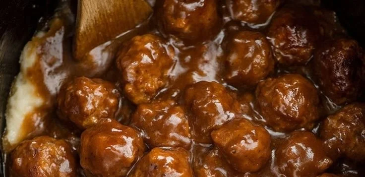 Delicious slow cooker Salisbury steak meatballs served with gravy and mashed potatoes.