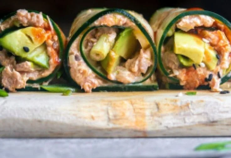 Spicy tuna salad rolls served on a plate with fresh ingredients