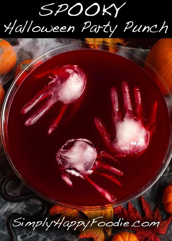Spooky Halloween party punch in a cauldron with Halloween decorations