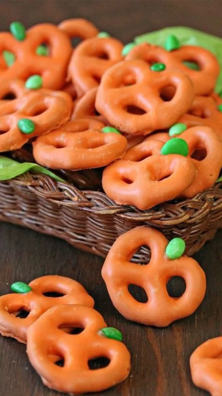 Plate of colorful healthy Halloween snacks including fruits and vegetables.