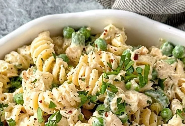 Delicious tuna pasta salad served in a bowl with fresh vegetables.