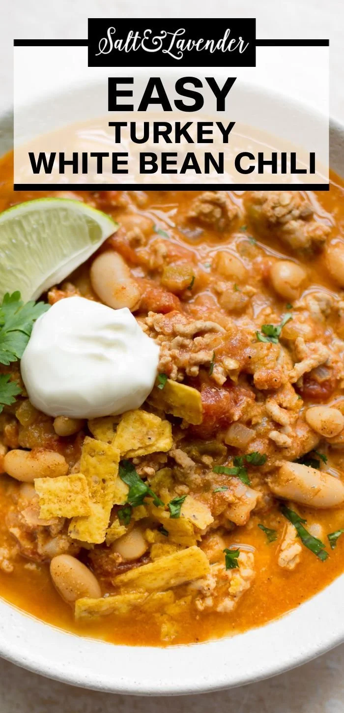 Delicious Turkey White Bean Chili garnished with fresh herbs in a bowl